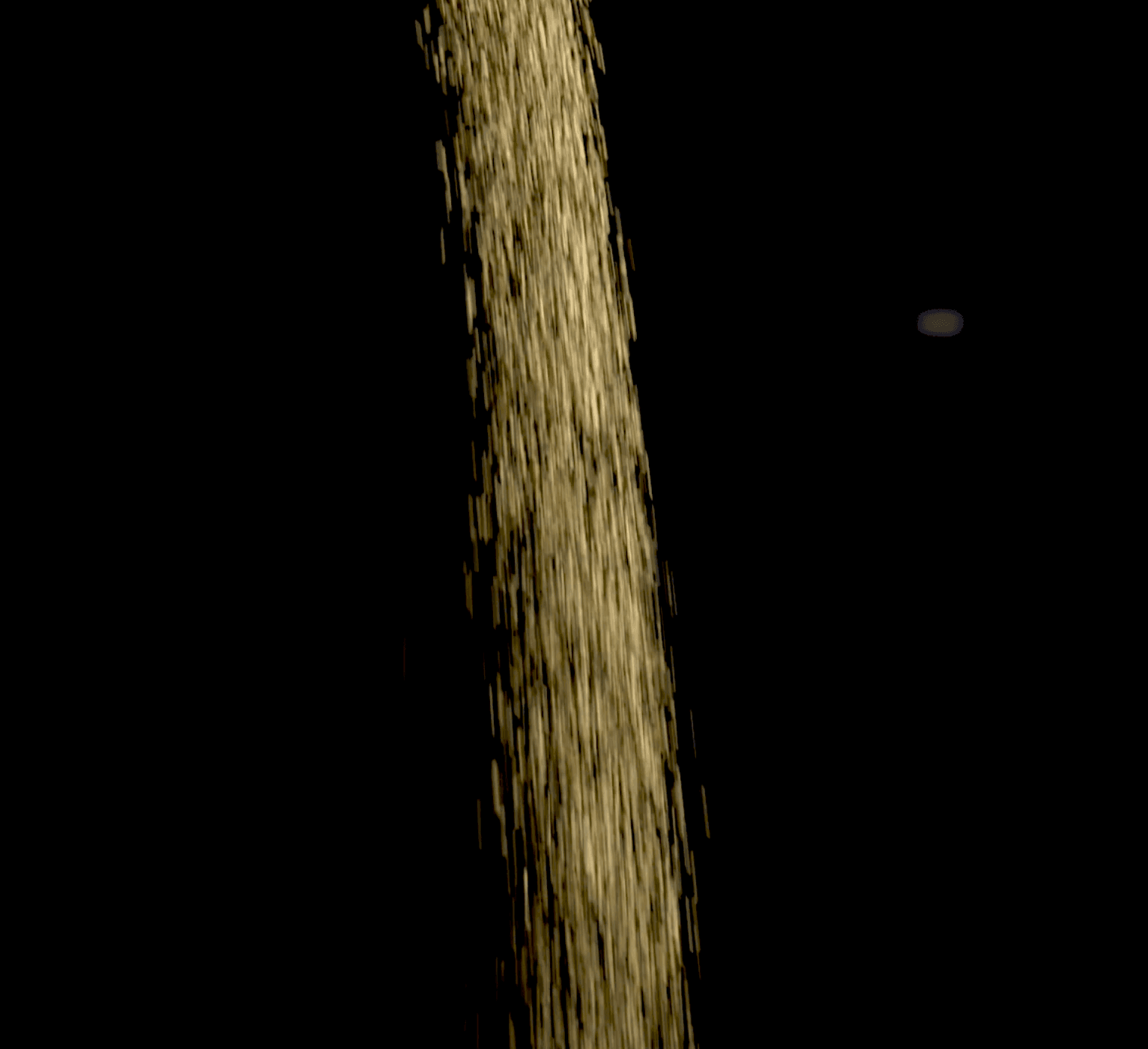 Stream of golden sand falling against a dark background.